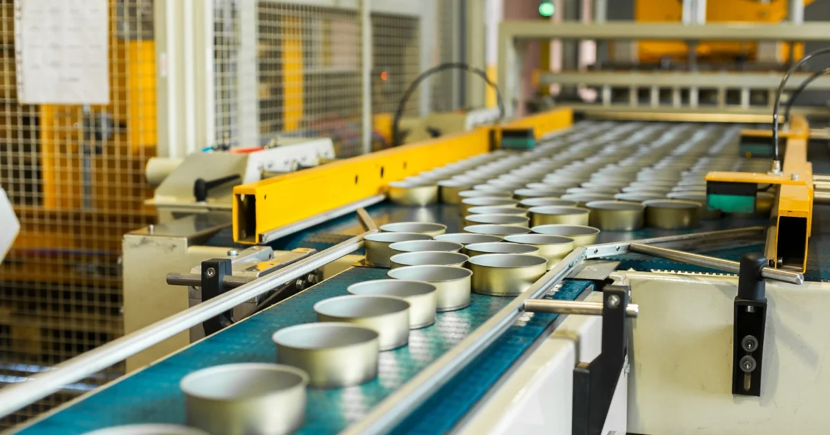 Metal tins on conveyor in factory