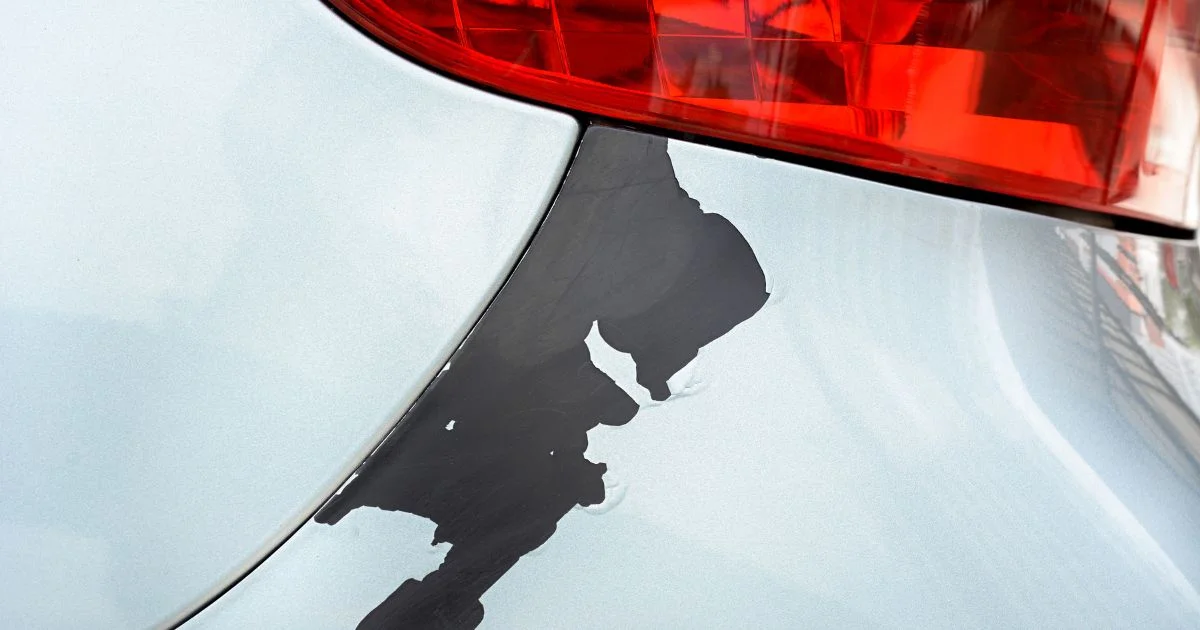 Close-up of peeling paint on car body.