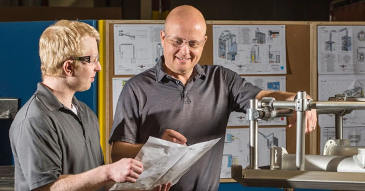 Engineers reviewing industrial equipment design drawings