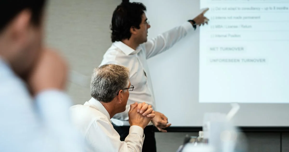 Team reviewing project timeline in production meeting