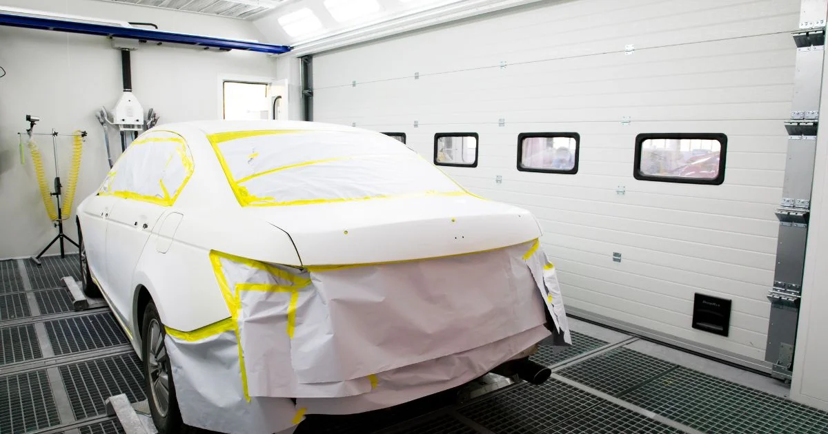 Car masked for painting in spray booth
