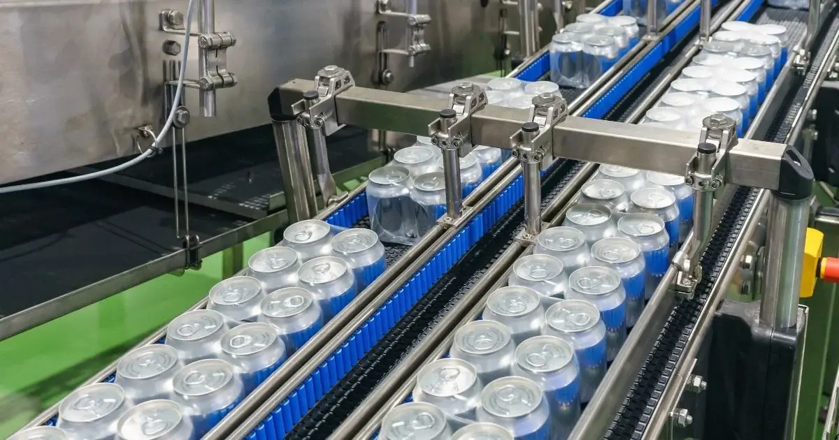 Beverage cans moving along automated production line
